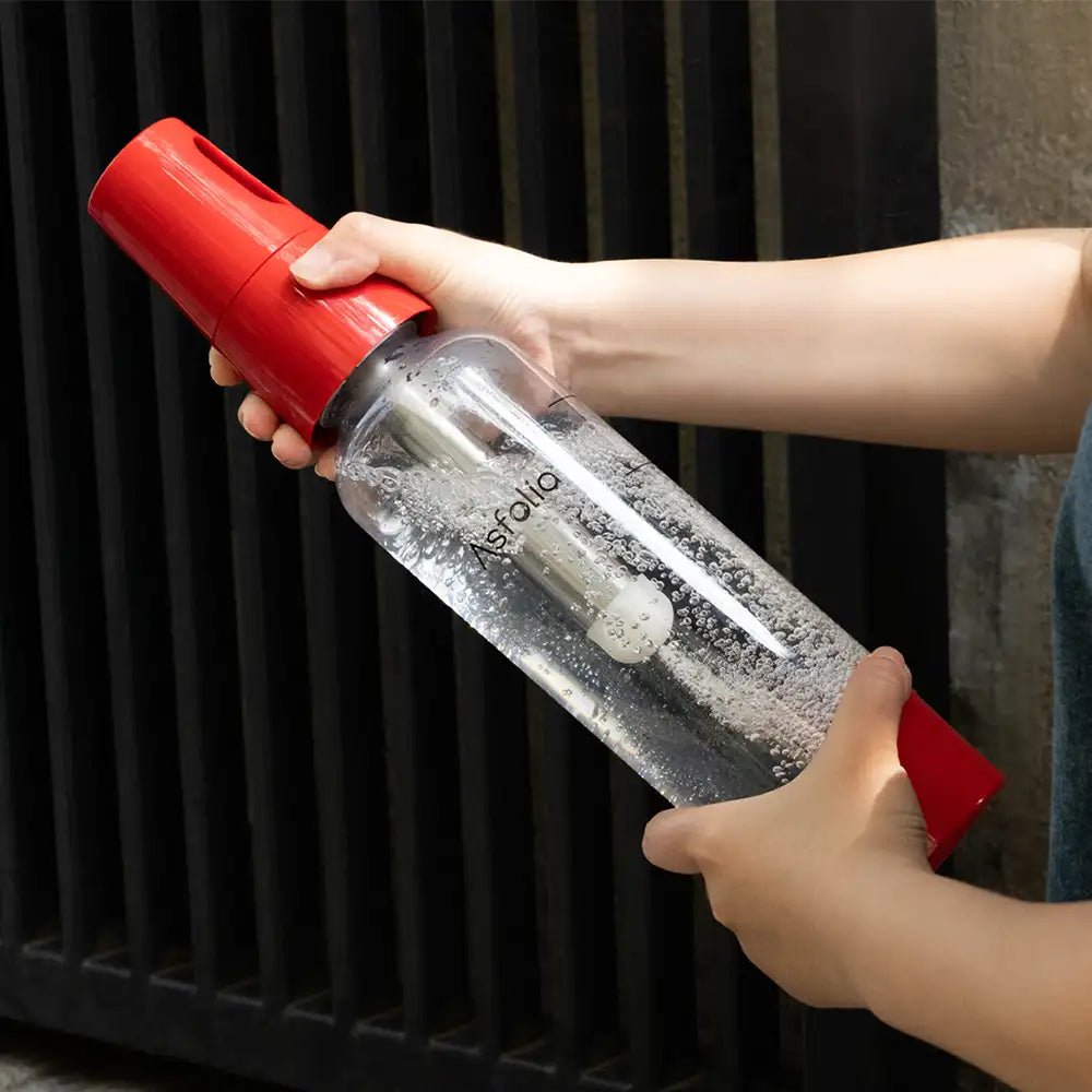 Hand Holding Asfolia Portable Soda Maker with Red Cap#color_red