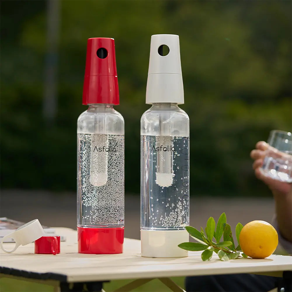 Asfolia soda makers with red and white caps on an outdoor table